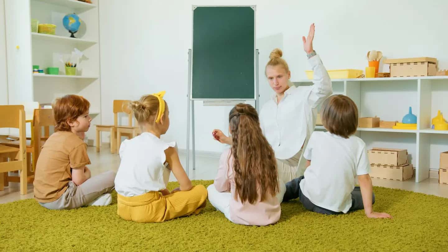 Children Listening to Woman While Sitting on Carpet