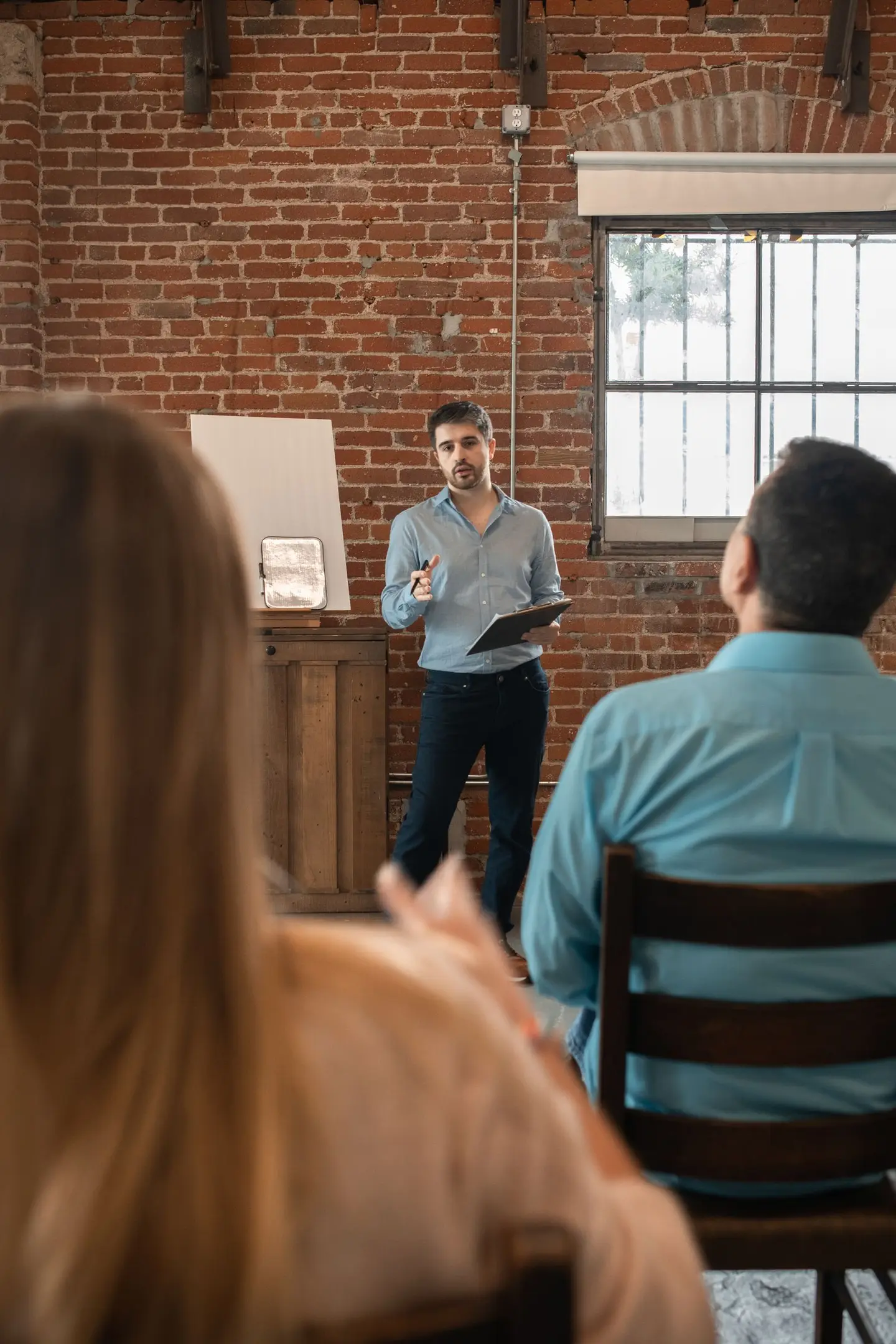 Handsome Man Discussing in Front of a Class