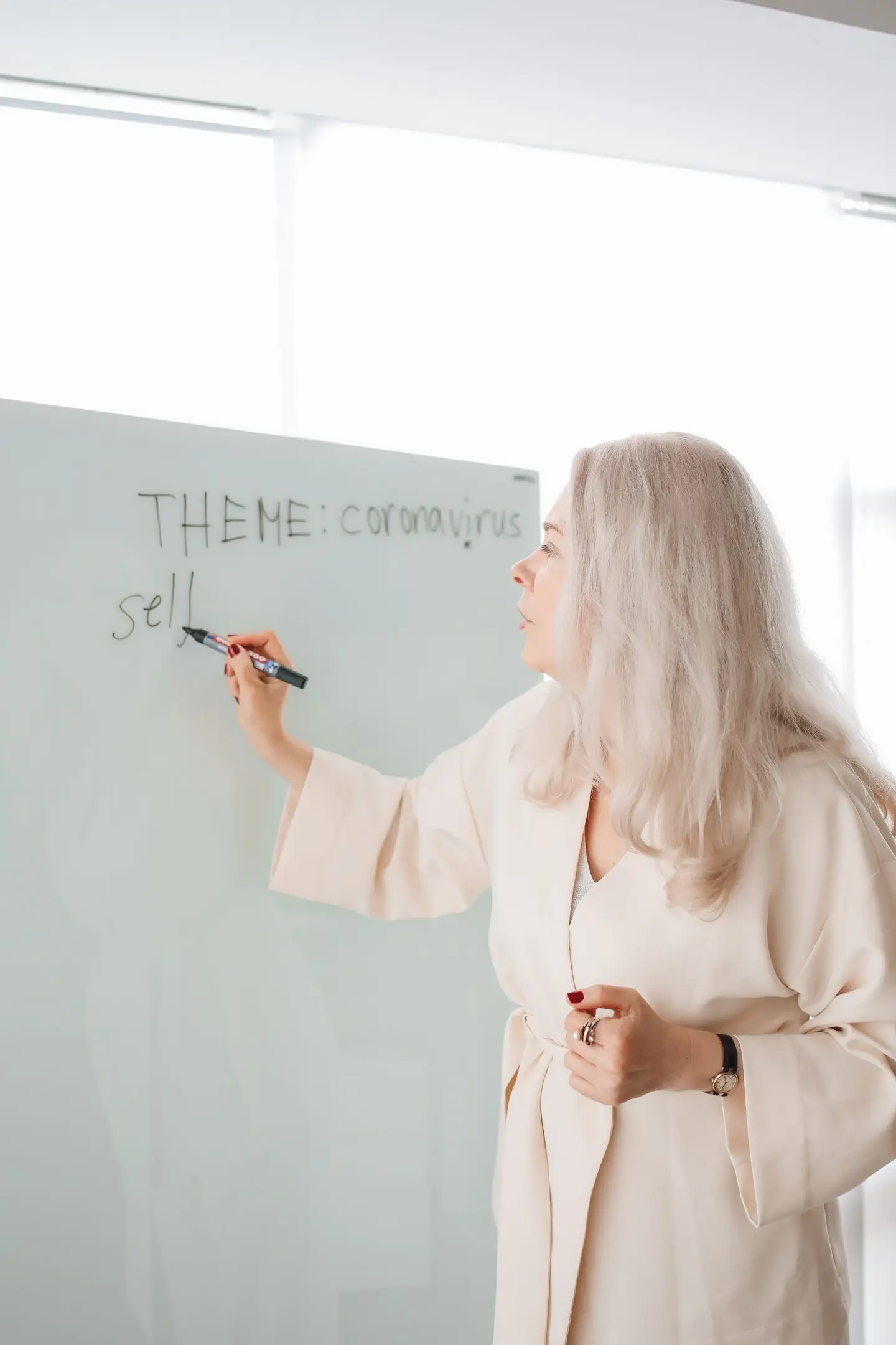 Teacher Writing on White Board