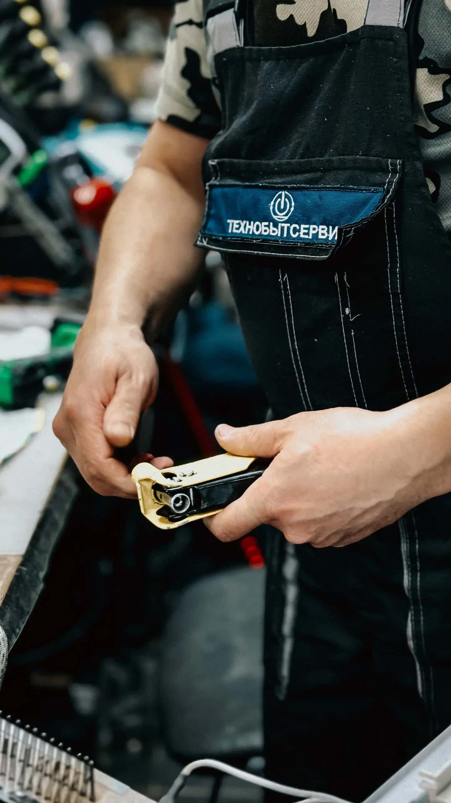 Worker Using Plumber's Tool in Workshop