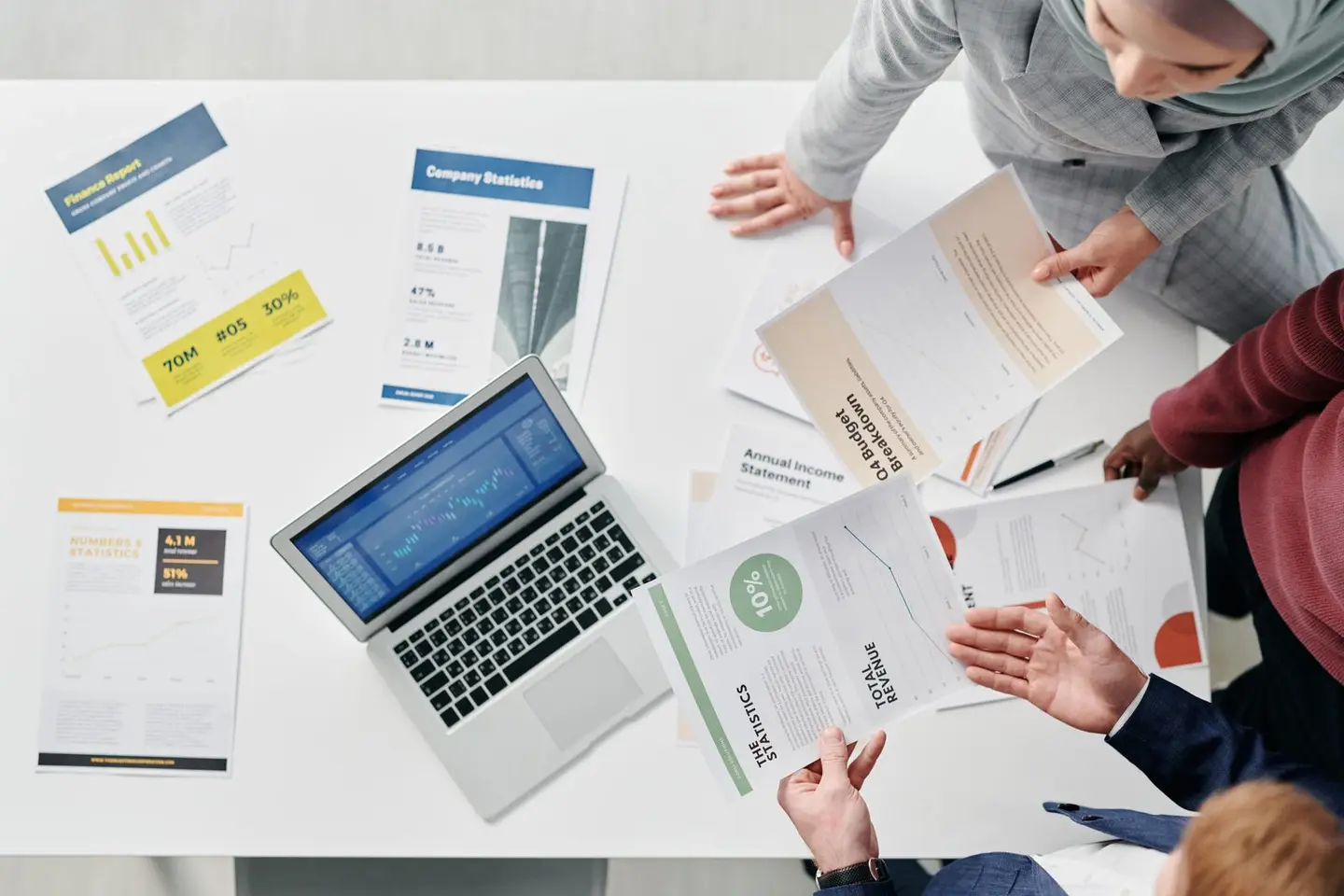 People in the Meeting Holding Documents
