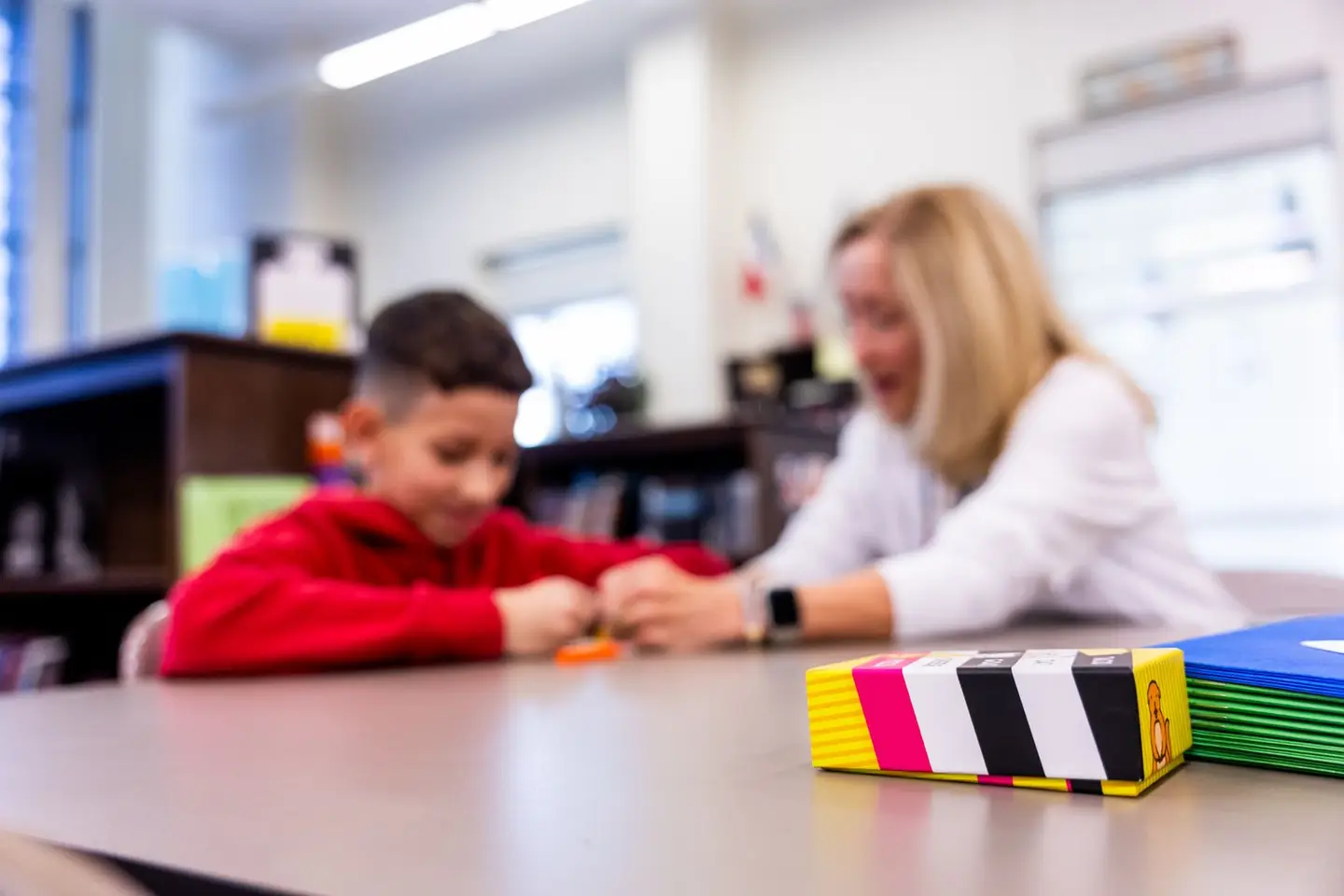 Child Learning with Teacher in Classroom