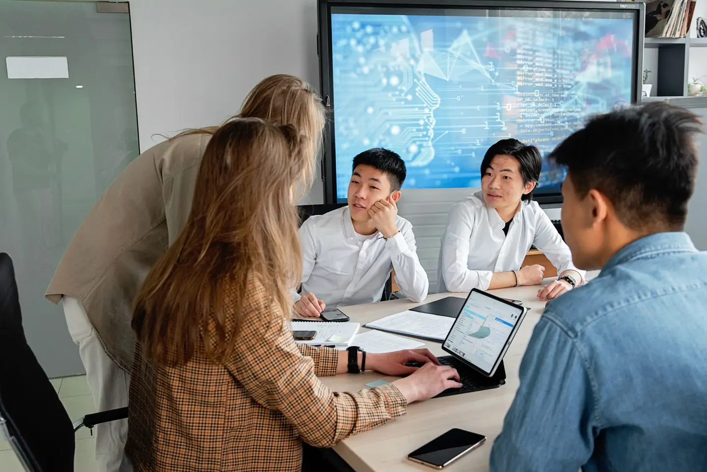 A team discussing work around a meeting table