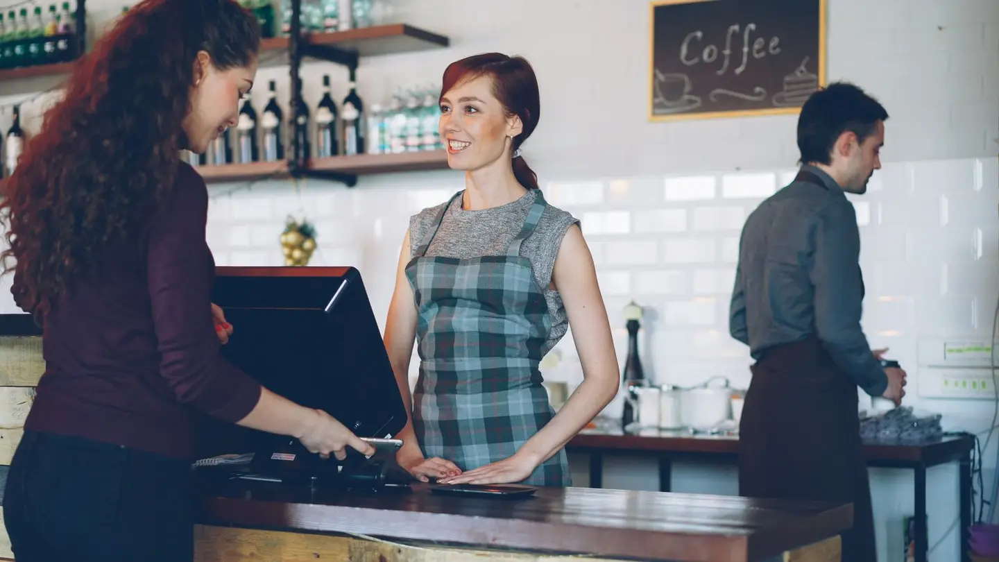 A restaurant team taking an order at the counter